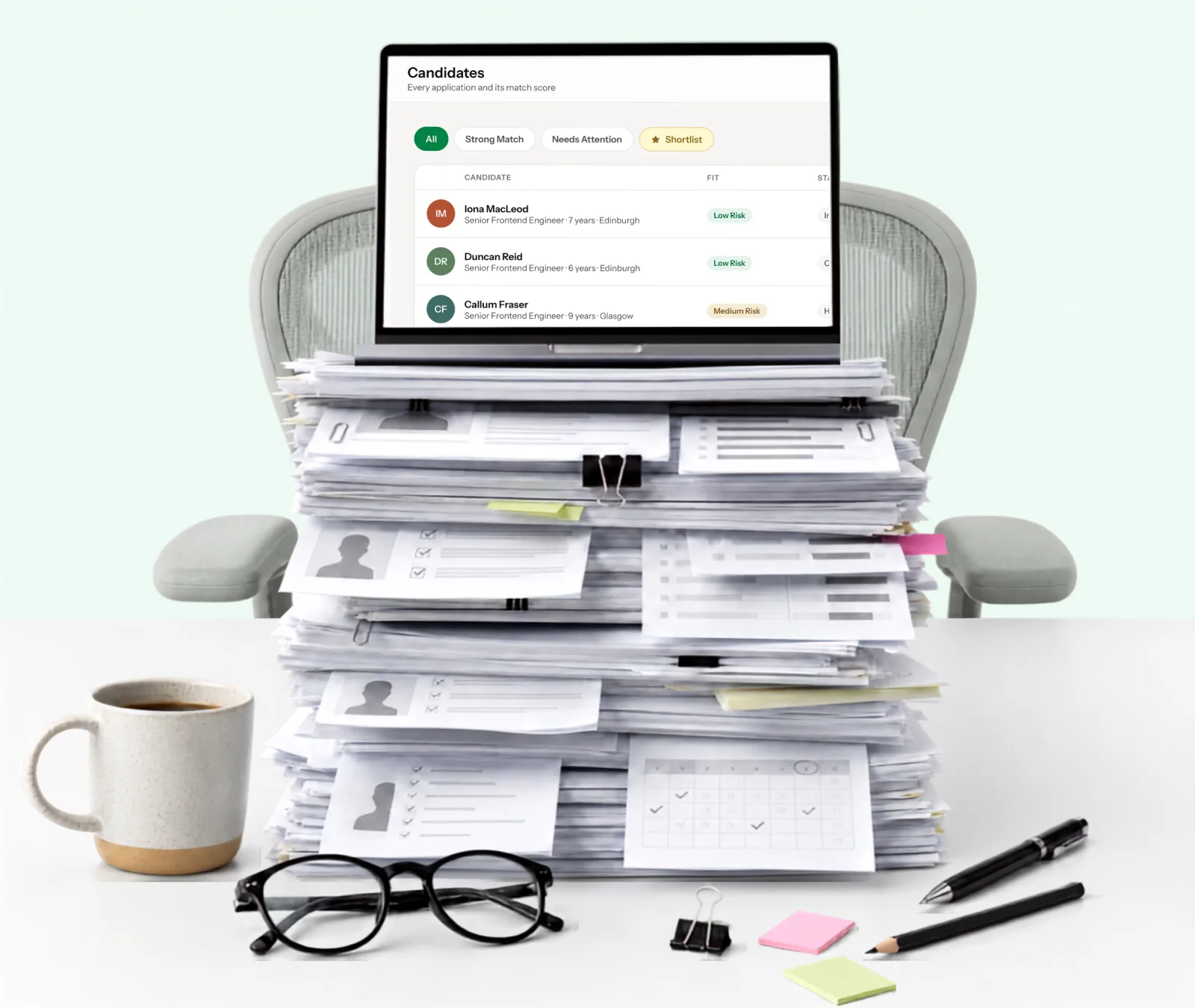 A laptop resting on a tall stack of printed CVs, its screen showing the StoA candidate list with match scores